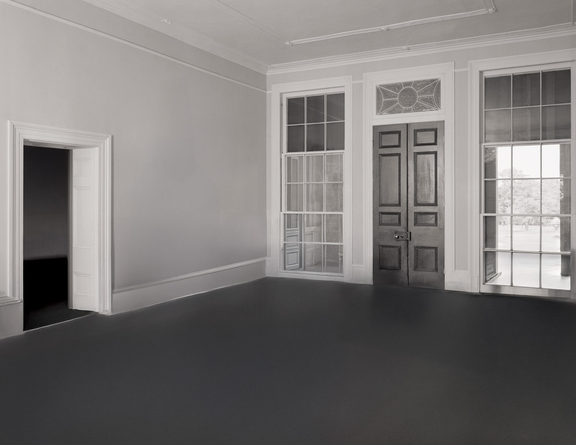 Interior of palladian style house has door mouldings, window mouldings, ceiling mouldings, hardwood floors, and is whitewashed.