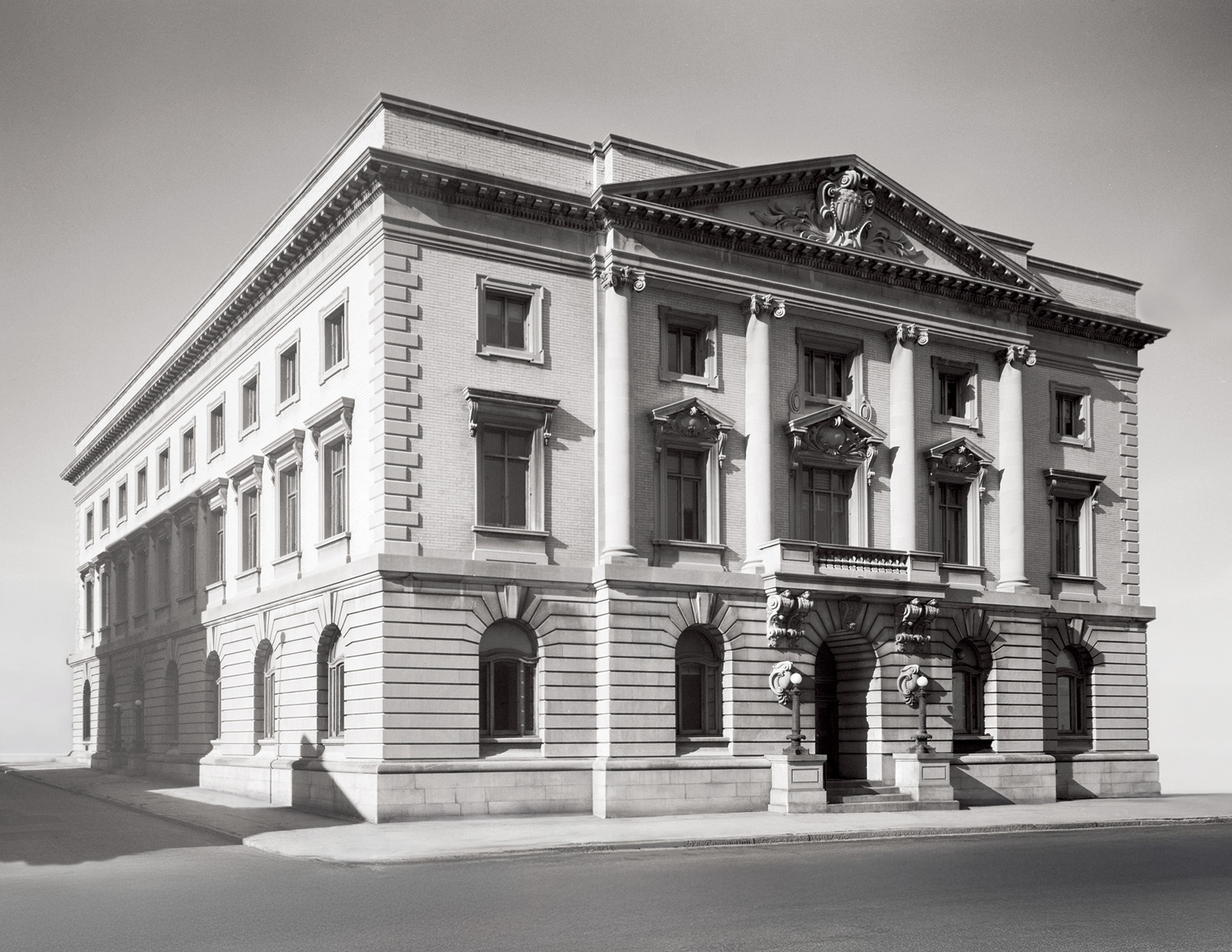 Stone palladian style building featuring cornice mouldings, window mouldings, an interesting design on face of building utilizing pillars.
